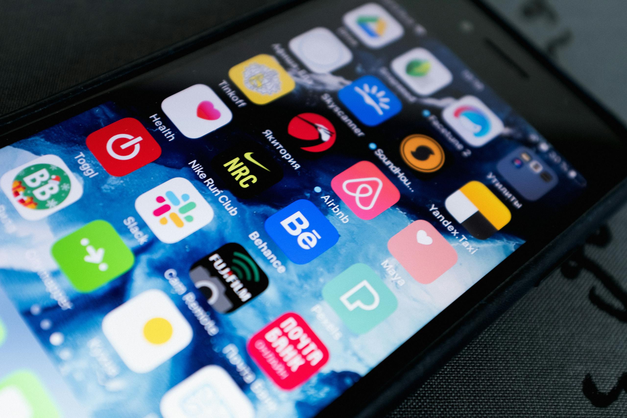 Detailed view of smartphone displaying multiple app icons on screen, highlighting technology use.