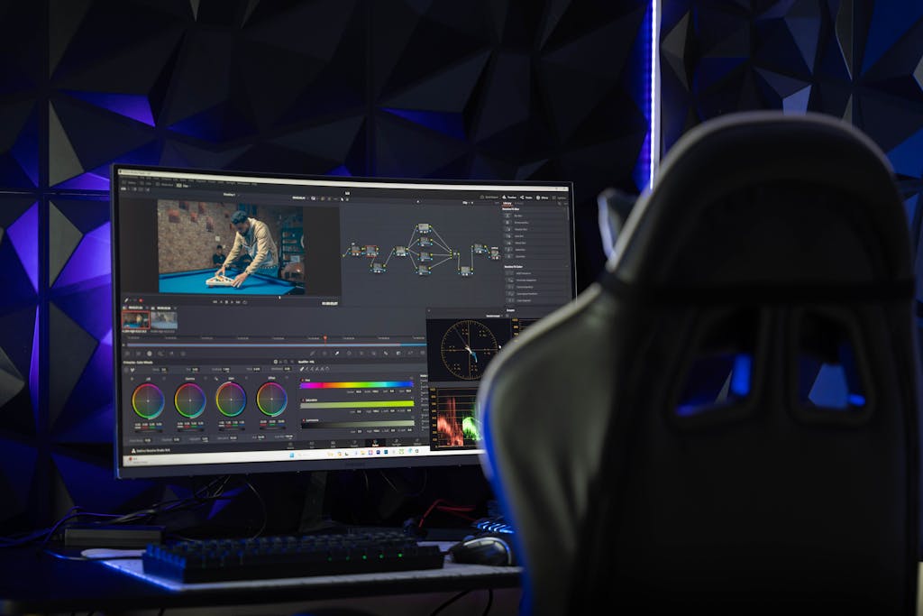 Curved monitor displaying video editing software in a tech-savvy workspace with mood lighting.